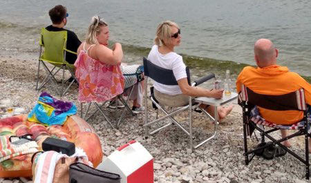 guests sitting on the lake erie shoreline